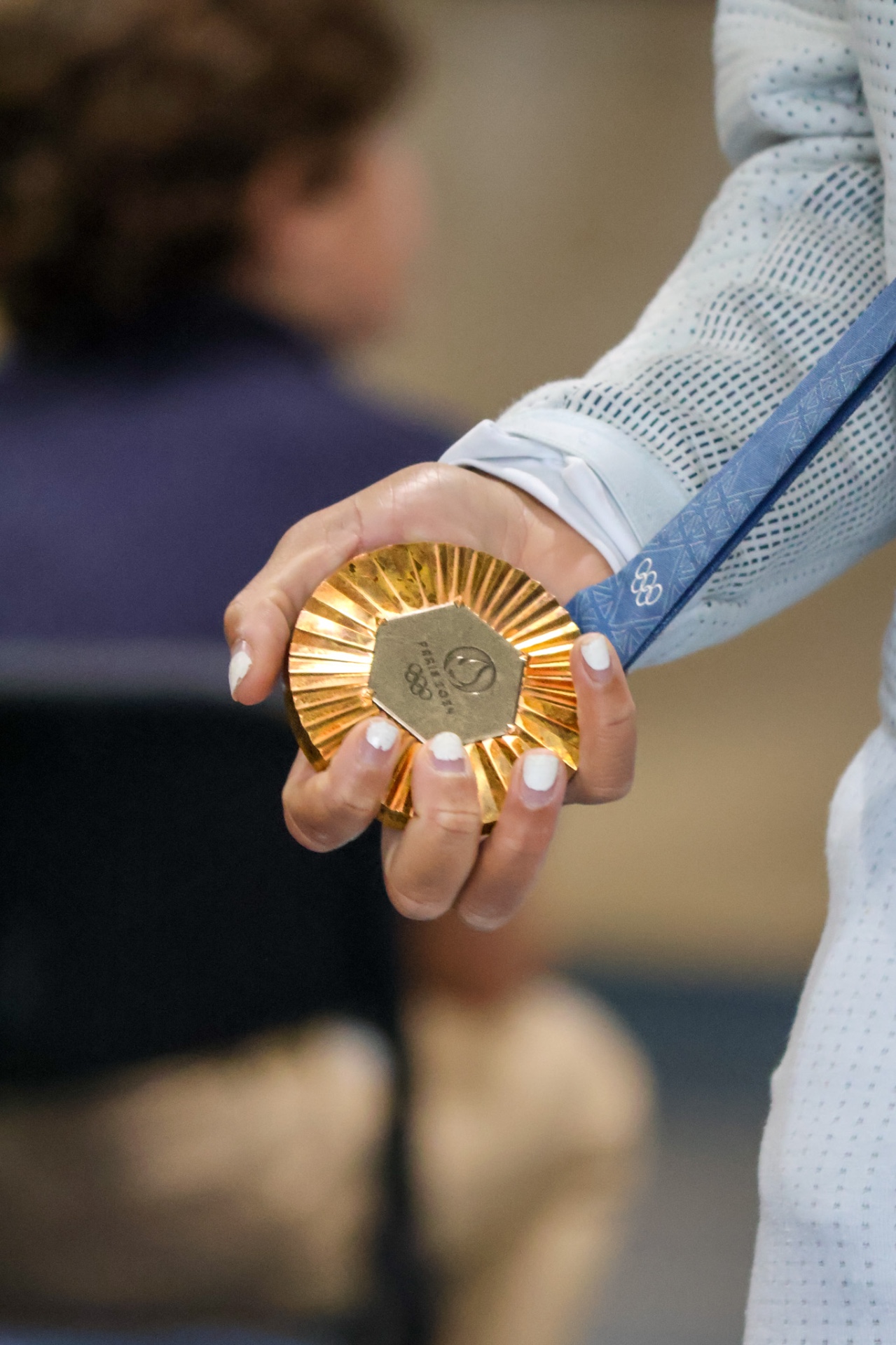 Ariana Ramsey holding her Olympic medal